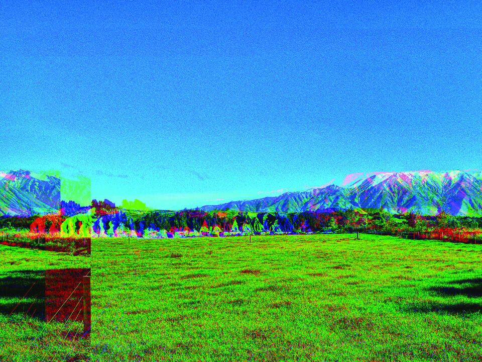 Bright digital landscape of green field with scattered pixel blocks and artificial clarity.